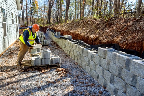 Concrete block wall that is being built on part new retaining wall construction project Retaining Walls